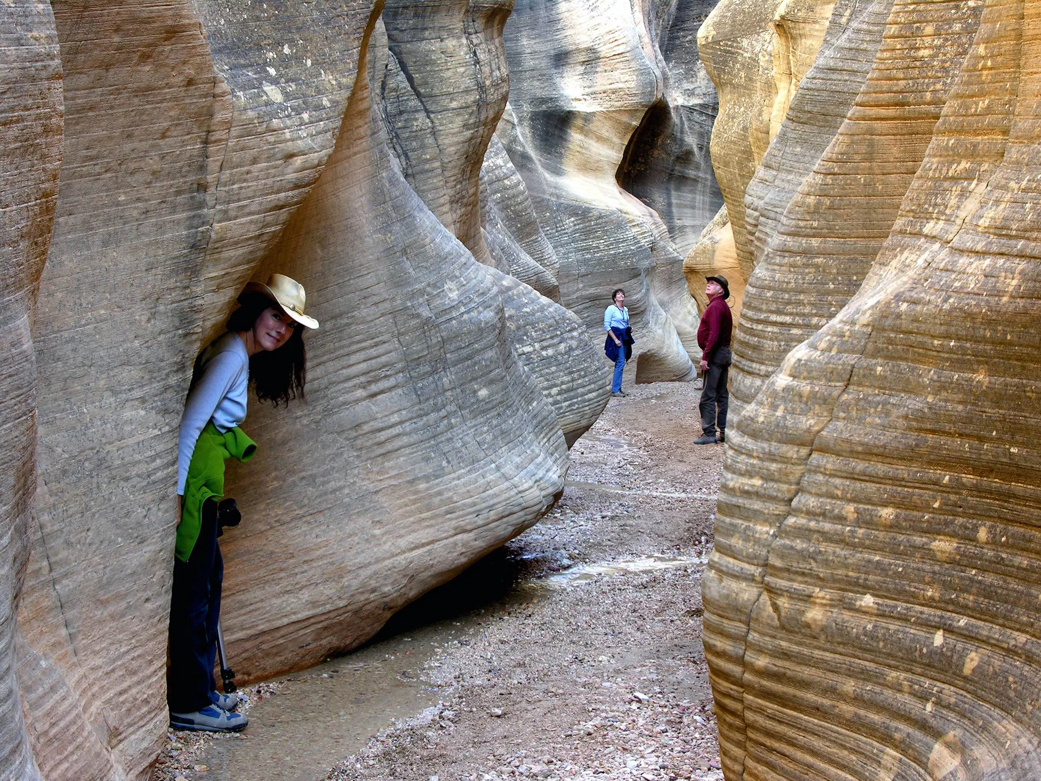 Hikers explore a stunning slot canyon in Grand Staircase-Escalante National Monument.