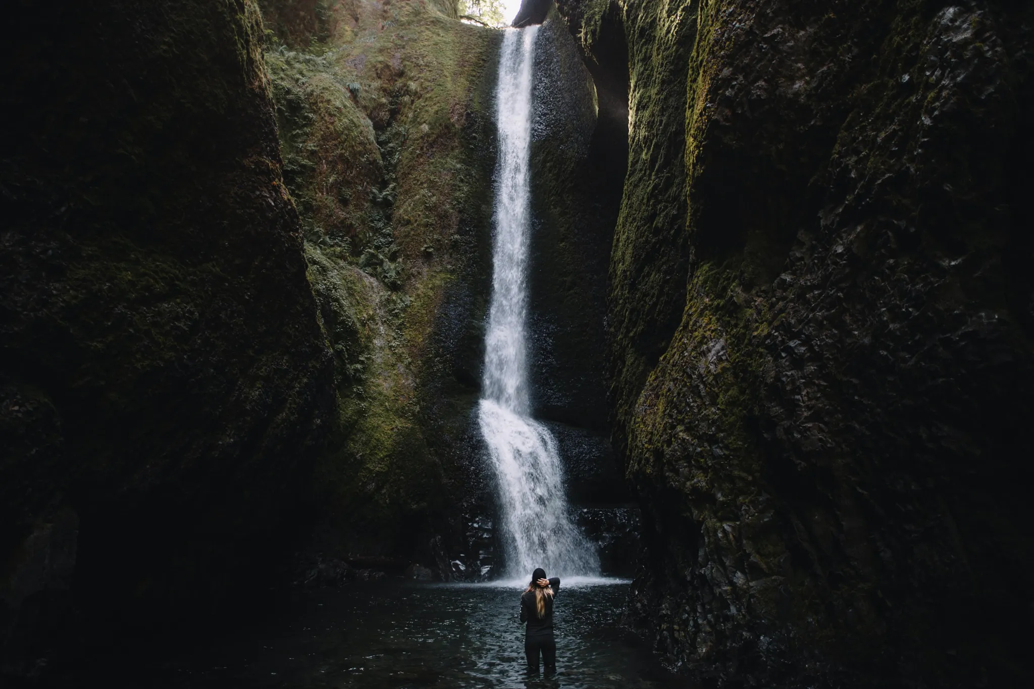 Person Standing In Front Of A Waterfall in Oregon