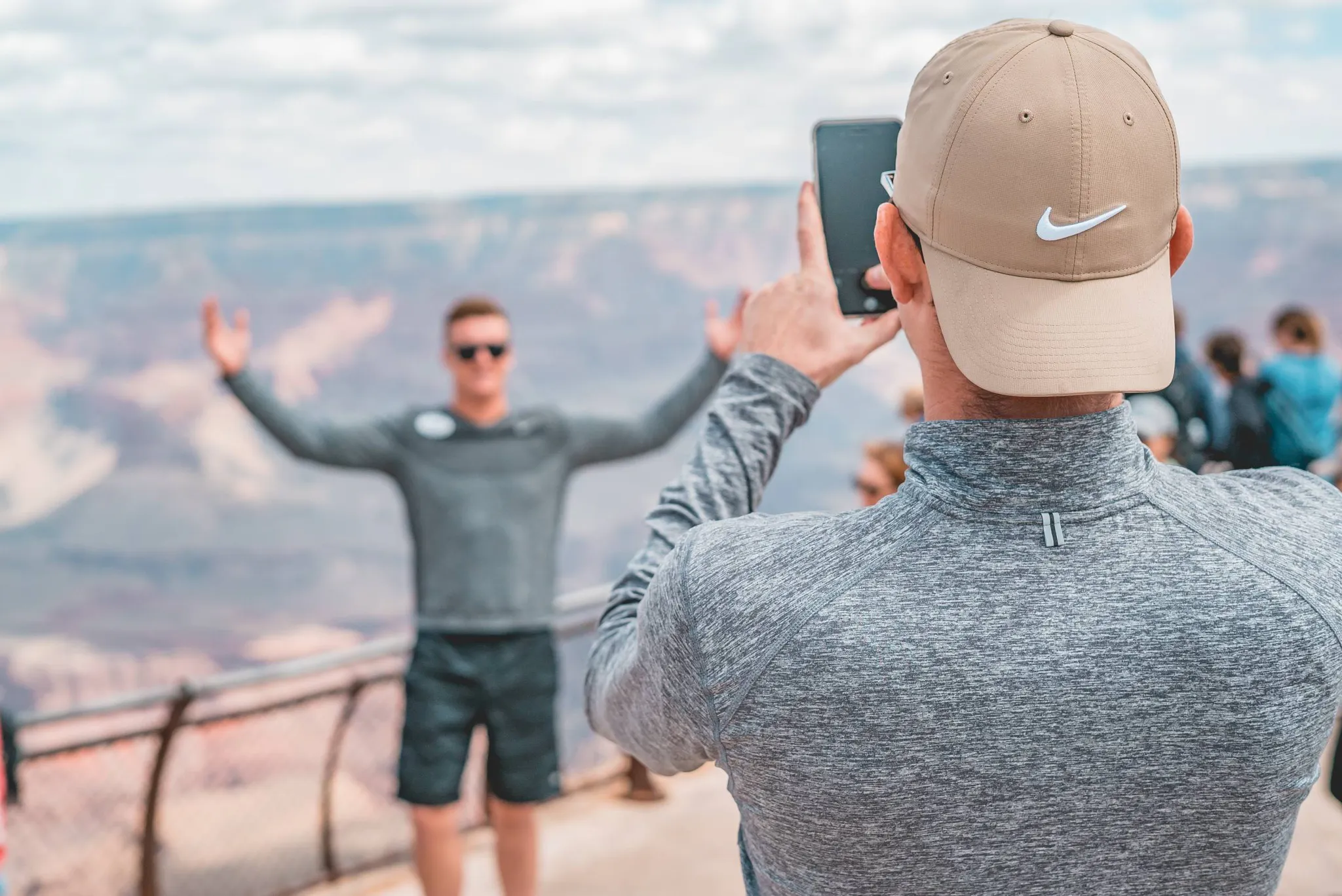 Man Taking A Photo Of A Friend At The Grand Canyon